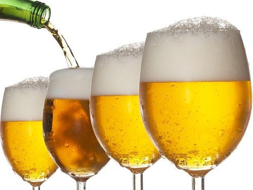 Pouring beer into four glasses with white background
