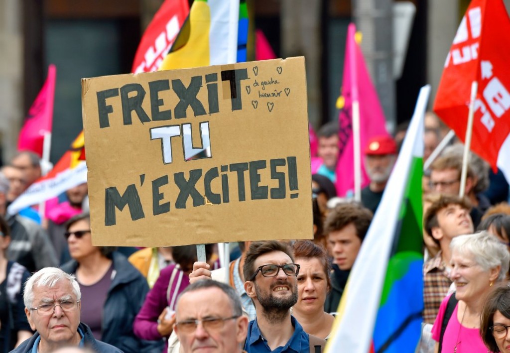 A demonstrator holds a placard reading "Frexit you excite me!" during a protest against controversial labour reforms, on June 28, 2016 in Nantes, western France. People took to the streets in France on June 28 in the latest protest march in a marathon campaign against the French Socialist government's job market reforms. Last month the government used a constitutional manoeuvre to push the bill through the lower house without a vote in the face of opposition from Socialist backbenchers. / AFP / LOIC VENANCE (Photo credit should read LOIC VENANCE/AFP/Getty Images)
