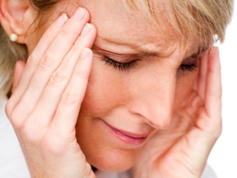 young blond woman having a headache close up