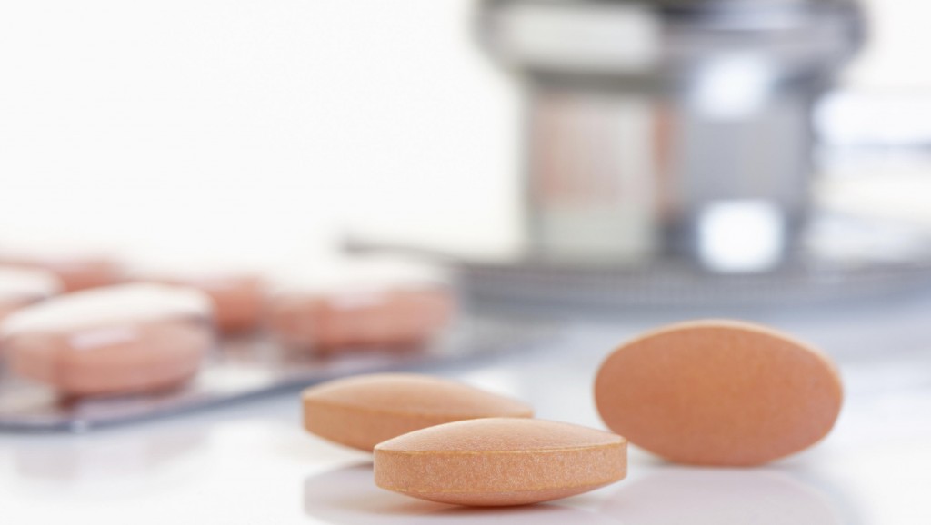 Close up of a Statin tablet - the controversial cholesterol lowering drug. Shallow d o f