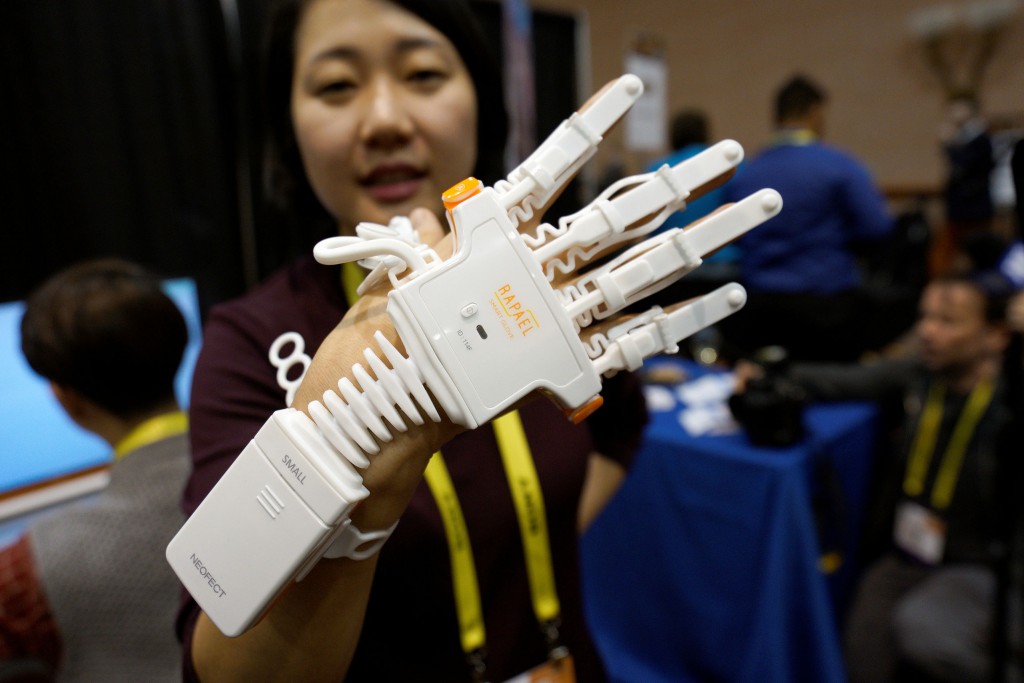 Anna Choi of Neofect demonstrates the Rapael Smart Glove therapy device for stroke victims at CES in Las Vegas, January 3, 2017.  REUTERS/Rick Wilking - RTX2XFS7