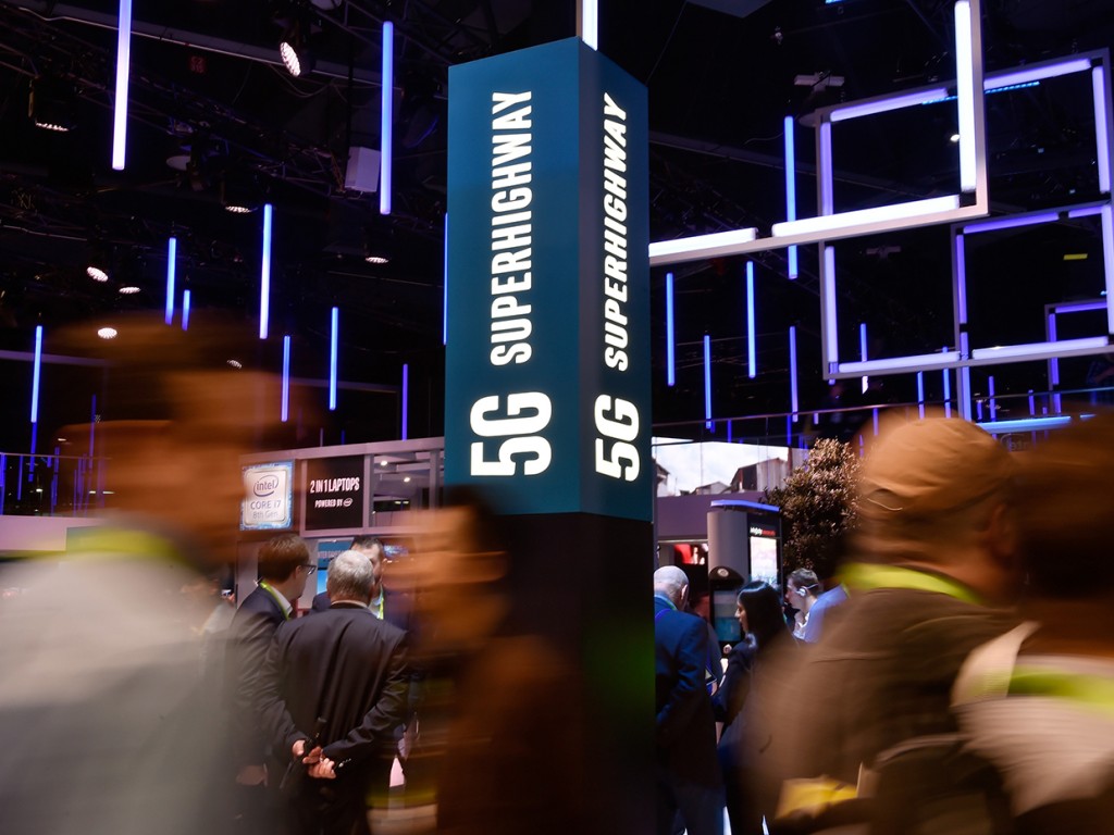 LAS VEGAS, NV - JANUARY 09: Attendeess pass by signage for 5G technology at the Intel booth during CES 2018 at the Las Vegas Convention Center on January 9, 2018 in Las Vegas, Nevada. CES, the world's largest annual consumer technology trade show, runs through January 12 and features about 3,900 exhibitors showing off their latest products and services to more than 170,000 attendees. (Photo by David Becker/Getty Images)